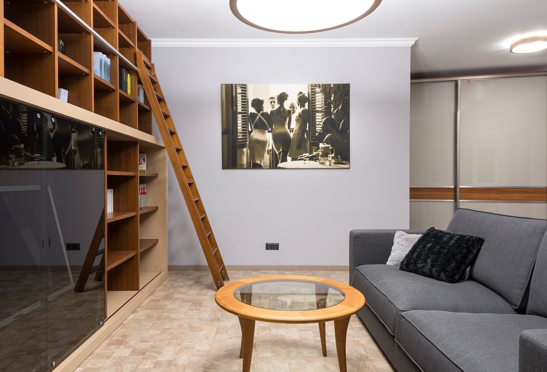 A sitting room with full-height shelving beside the sofa